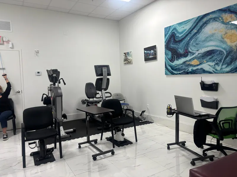 Exercise bike area with recumbent bikes and a staff workstation at All In One Specialty Health in Miami Gardens